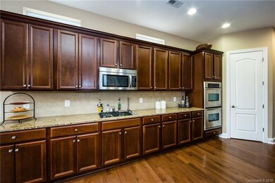 Large Kitchen with double oven. Door leads to Walk