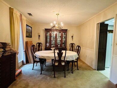 Dining area with a notable chandelier, carpet, a t