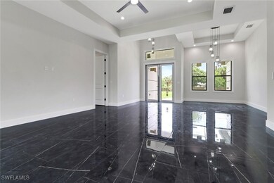 Spare room featuring a raised ceiling, a ceiling f