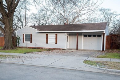 Ranch-style house with a garage, concrete driveway
