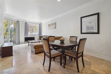Dining space featuring ornamental molding, light t