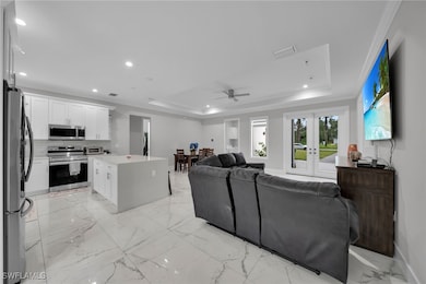 Living area with a raised ceiling, ceiling fan, re