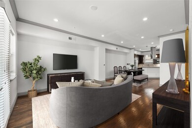 Living room featuring sink and dark wood-type floo