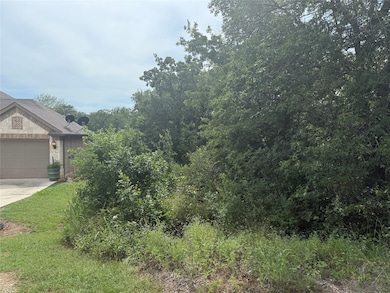 View of yard featuring driveway and a garage