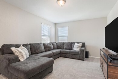 Living room featuring light colored carpet and baseboards