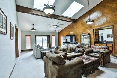 Carpeted living room featuring vaulted ceiling wit