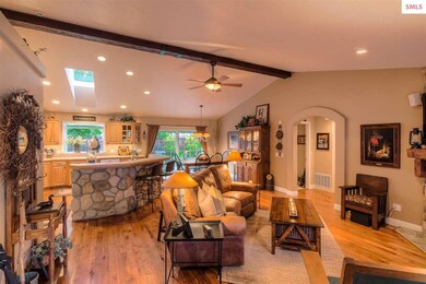 Vaulted ceilings, warm hickory wood floors, beam w
