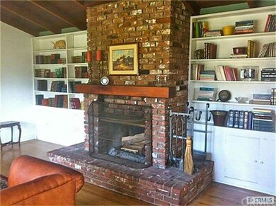 Used brick hearth a wall of built-ins  and ...