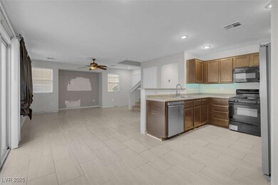 Kitchen featuring ceiling fan, sink, kitchen penin