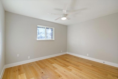 Empty room featuring light wood-type flooring, ba
