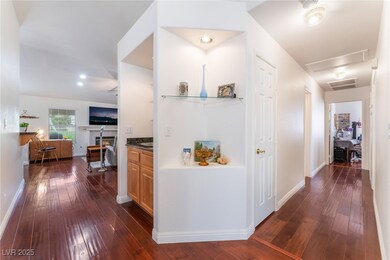 Corridor with baseboards, visible vents, and dark