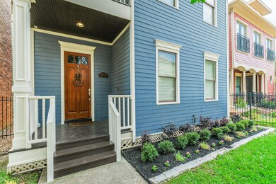 A covered front porch and fully fenced yard greet
