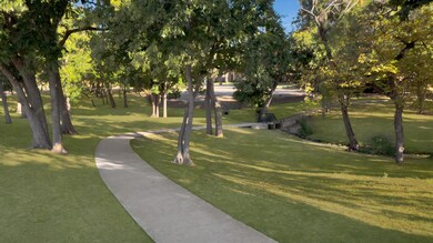 San Chester Park features walking trails leading you around a pond with fountain.
