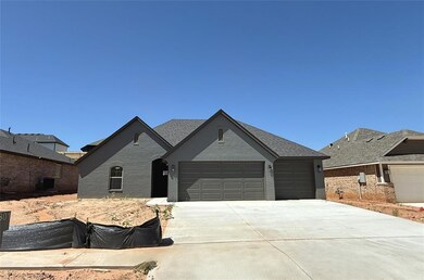 View of front of house featuring a garage, brick siding, and concrete driveway