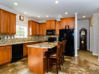 Upgraded kitchen with granite and black splash
