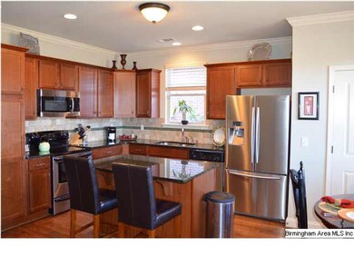 Kitchen has granite counters and upgraded backspla
