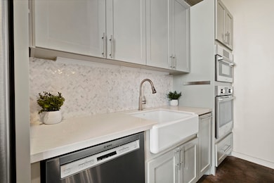 DEEP FARMHOUSE SINK IS ACCENTED BY STUNNING TILE B