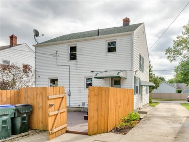 Back of home with a fenced in yard