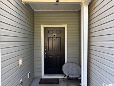 View of exterior entry featuring covered porch