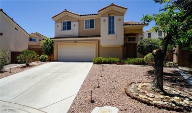 View of front of home featuring a tiled roof, conc