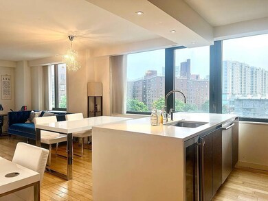 Kitchen featuring wine cooler, a sink, light wood finished floors, and a chandelier