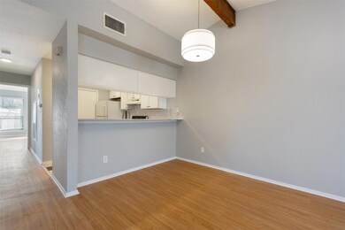 Kitchen featuring wood finished floors, under cab