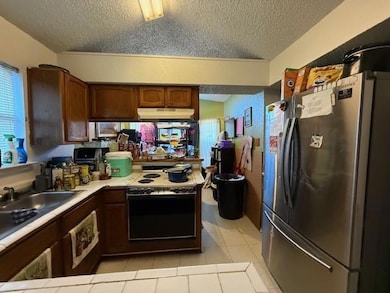Kitchen featuring sink, stainless steel refrigerat