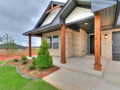 Property entrance with a porch, board and batten siding, and brick siding