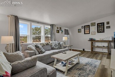 Living room with LVP style floors, and lofted ceil
