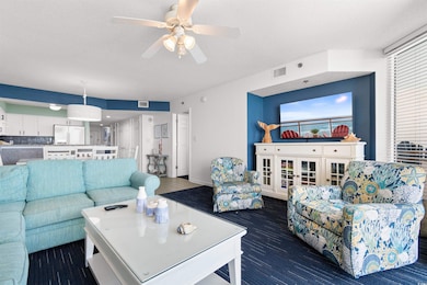 Living room featuring ceiling fan and a textured ceiling