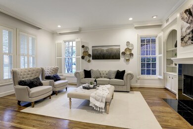 This formal living room with wooden floors has ple