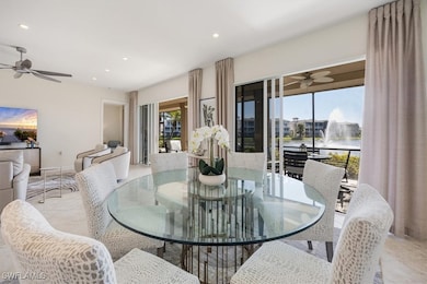 Dining space featuring a ceiling fan, light tile patterned floors, a water view, and recessed lighting