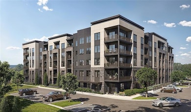 View of apartment building / complex featuring uncovered parking