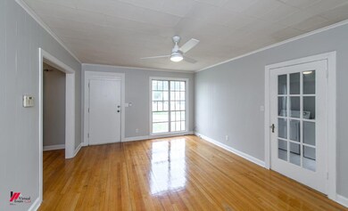 Unfurnished room with crown molding, ceiling fan, 