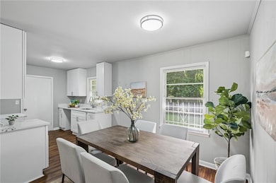 Kitchen and dining feature sleek new modern light fixtures to brighten the space. Dining area has space to seat 6.