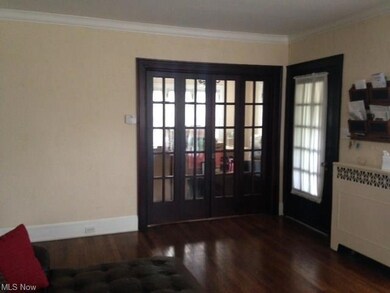 Parlor Doors go into a large area with big bright windows. The Front door leading to the vestibule is also here on the right.