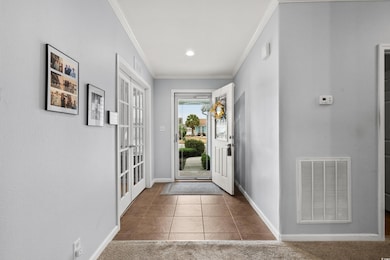 Foyer entrance featuring ornamental molding, frenc