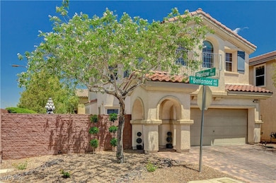 View of front of home featuring a tiled roof, a ga
