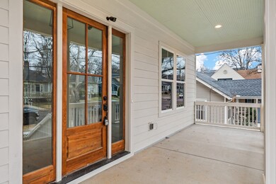 The front porch has a beautiful bead-board ceiling and stained wood front door with decorative glass inserts and sidelights on both sides.