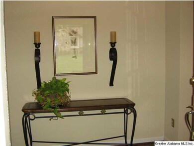 Entry hall is warm and inviting with hardwoods tho
