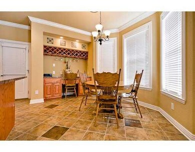 Cafeteria/Kitchen. Wine rack, message center, pantry closet and bay window view of backyard