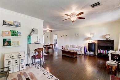 Living room with view of dining room and kitchen.