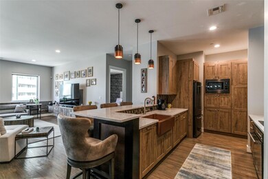 Kitchen with hanging light fixtures, sink, black a