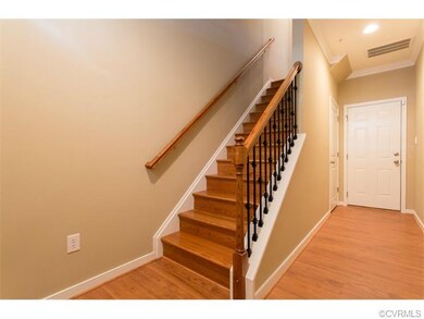 Gorgeous foyer with hardwood floors, neutral paint