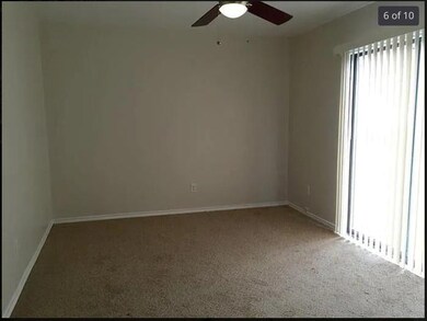 Carpeted spare room featuring a ceiling fan and b