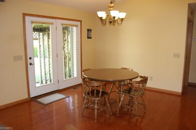 Dining area with wood floor & atrium door to patio