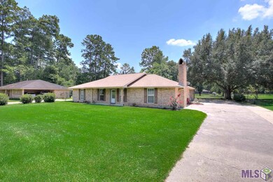 Front of home with ample parking and a rear carpor