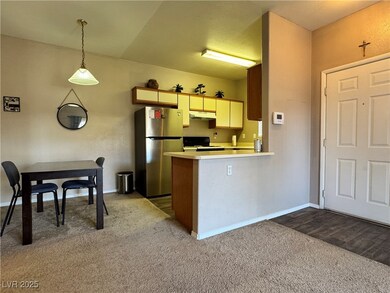 Kitchen featuring freestanding refrigerator, range