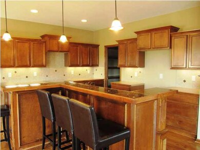 Kitchen offers wood floors, granite countertops an
