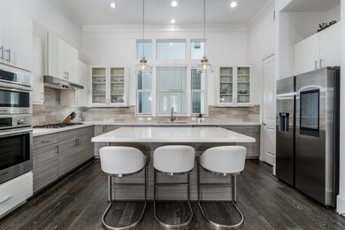 Fall in love the moment you step into this breathtaking kitchen, where soaring ceilings, an oversized island, and designer finishes create the heart of the home you've been dreaming of. Every detail invites you to gather, entertain, and enjoy life.